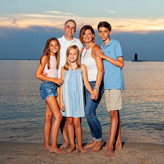 Family on the beach at sunset